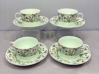 Four teacups on saucers showing full set