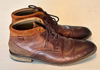 Right side view of both boots showing leather, suede collar, canvas heel panels