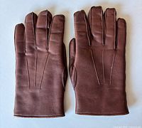 front view of gloves showing leather exterior and stitched darts