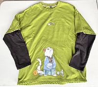 Full view of pullover front showing color, layered sleeves, graphics