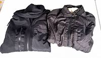Both jackets folded side by side