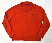 Full view of burnt orange quarter-zip sweater spread flat
