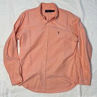 Front view of peach Ralph Lauren long sleeve button-down shirt laid flat