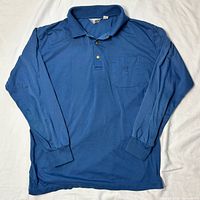Full view of blue long sleeve polo front side
