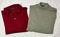 Both pullovers folded side by side, showing colors and styles