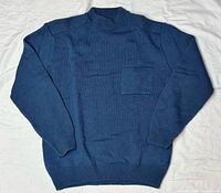 Front view of blue acrylic knit sweater showing chest pocket