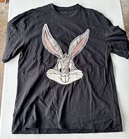 Full view of black Bugs Bunny t-shirt laid flat