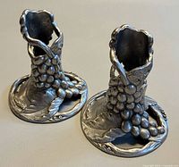 Two pewter candlestick holders front angle