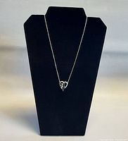 Full view of necklace on display bust showing chain length and pendant position