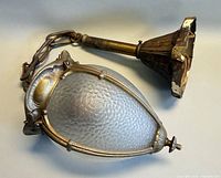 Full view of acorn pendant with frosted glass shade, brass frame, chain and canopy