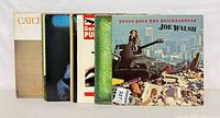 Front jackets of five records including Cat Stevens, SUB black cover, General Public, green snakeskin cover and Joe Walsh