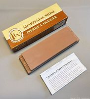Sharpening stone, box, care sheet displayed together