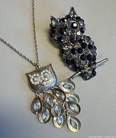 Front view of both owl jewellery pieces