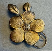 Front view of gold plated sterling flower brooch