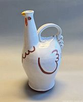 Left side view of rooster pitcher showing painted wing and tail handle