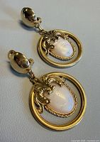 full view of both clip-on dangle earrings showing design and length