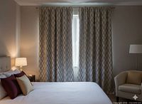 Curtains hung across window in bedroom setting