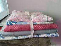 Stack of five folded fabrics tied together