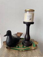 Candle on holder, duck box, and tray grouped together