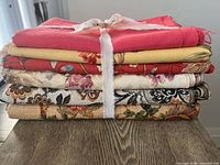 Stack of six folded fabric pieces tied together