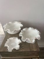 Three Fenton milk glass bowls grouped on table