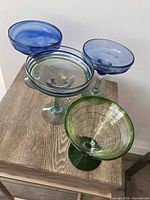 Top view of four hand-blown cocktail glasses highlighting colours and shapes