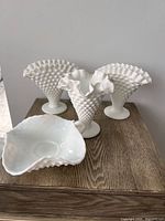 Four hobnail milk glass pieces on table