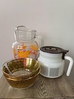 Two Culver bowls, daisy pitcher, milk glass server grouped on table