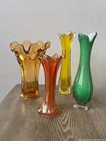 Four vases grouped on wood surface