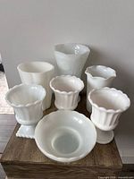 Front and top view of all seven milk glass pieces