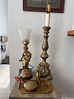 Overall view of both lamps, tray, cat figurine and crumb pan on table