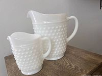 Pitcher and creamer side by side showing overall form and hobnail pattern