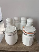 Group view of four apothecary jars and two clamp-lid canisters