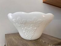 Milk glass punch bowl side view showing raised grape and leaf motif