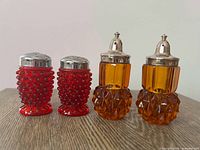 Group shot of both red hobnail and amber diamond-point shakers
