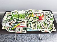 Wide view of table with large assortment of seed packets