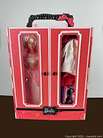 Closed wardrobe case showing doll and clothing through clear panels