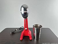 Front view of mixer with cup and cord