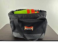 Cooler tote front view showing logo and partial contents