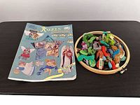 Book, hoop, and group of floss displayed on table