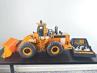 Left side view of 26-inch New Bright Caterpillar 992 loader with wired controller