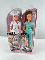 Front view of both MGA Dream Ella dolls in sealed boxes