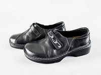 Left side view of both clogs showing uppers, strap design, and soles