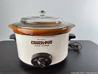 Front view showing full slow cooker with lid and dial