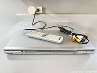 Sony DVP-NS63P player with remote and RCA cable on counter