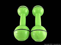 Top view of both green Sportline dumbbells showing brand and weight markings