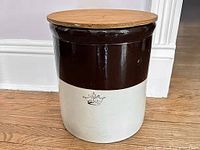 Crock with wooden lid in place, showing two-tone coloration