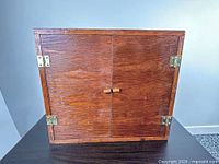 closed front view of cabinet showing wood finish and hardware
