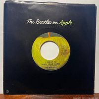 Front of sleeve with record inside showing Apple label through die-cut