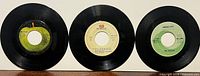 Three singles front view showing Apple, EMI, Capitol labels